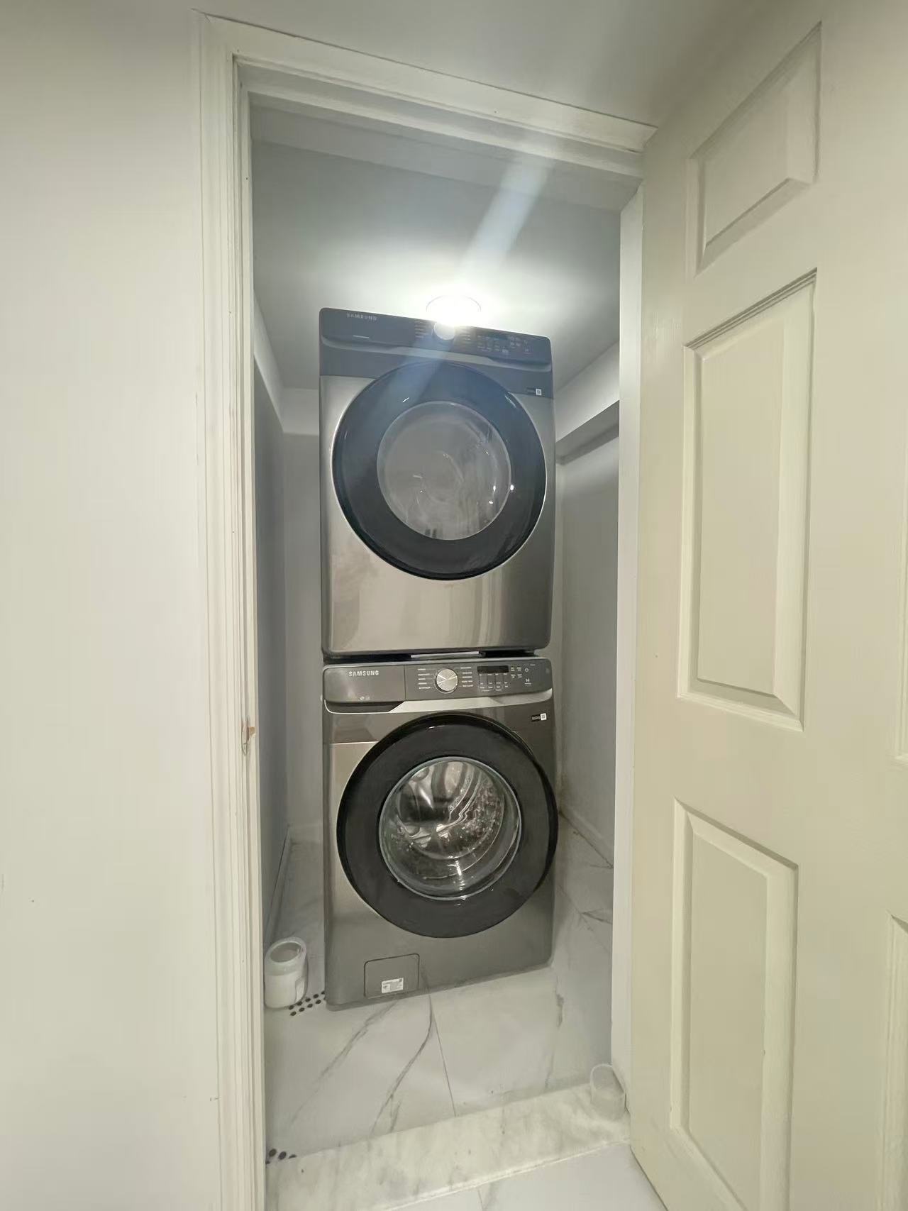 In-unit stacked Samsung washer and dryer in a renovated Fresh Meadows Queens house for rent.